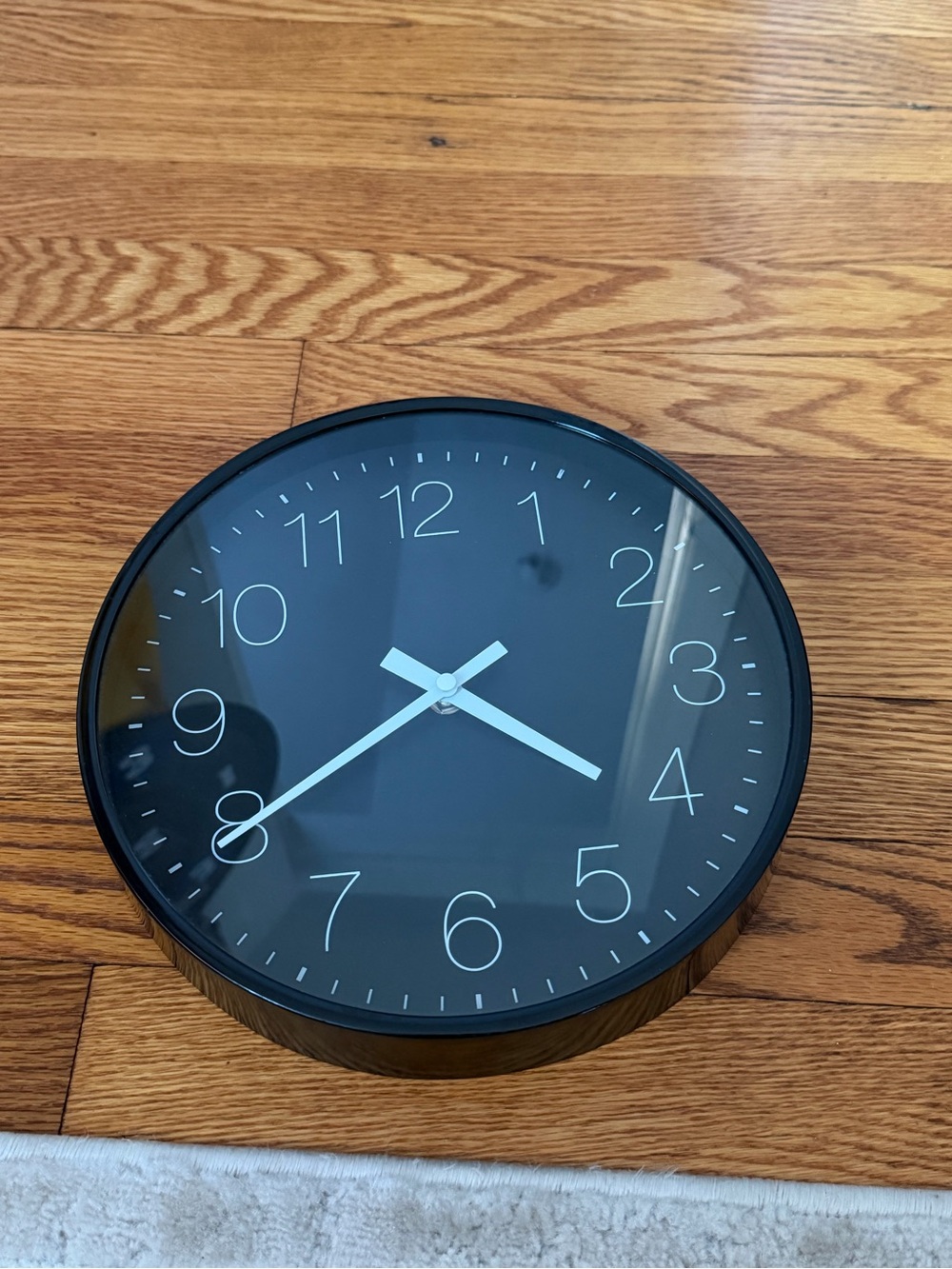 Minimalist Black Wall Clock with White Hands